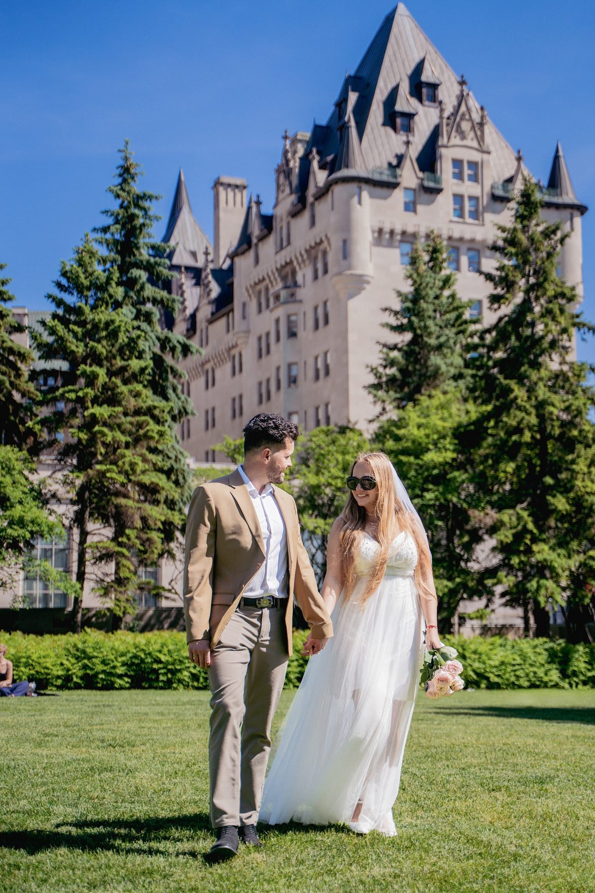 Couple walking by a historic hotel